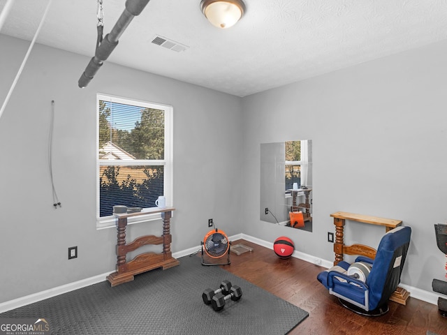 exercise area with dark hardwood / wood-style floors