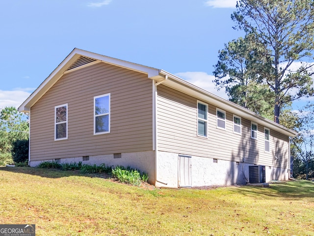 view of side of home with a yard