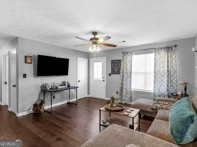 living room featuring a textured ceiling, dark hardwood / wood-style floors, and ceiling fan