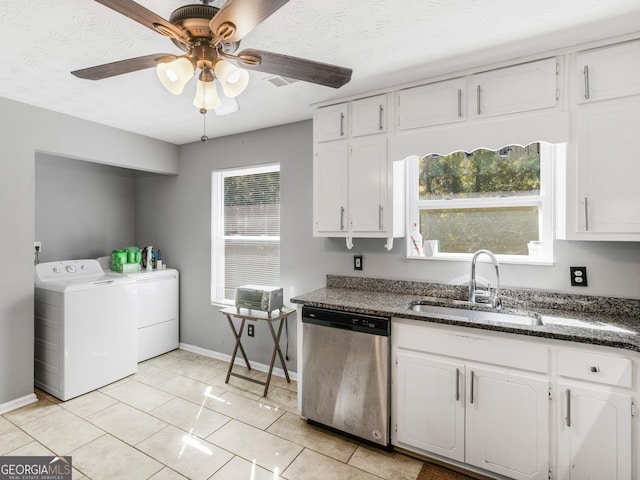 kitchen with white cabinets, separate washer and dryer, stainless steel dishwasher, and sink