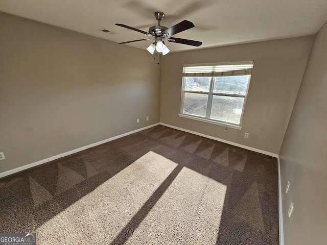 carpeted spare room with ceiling fan