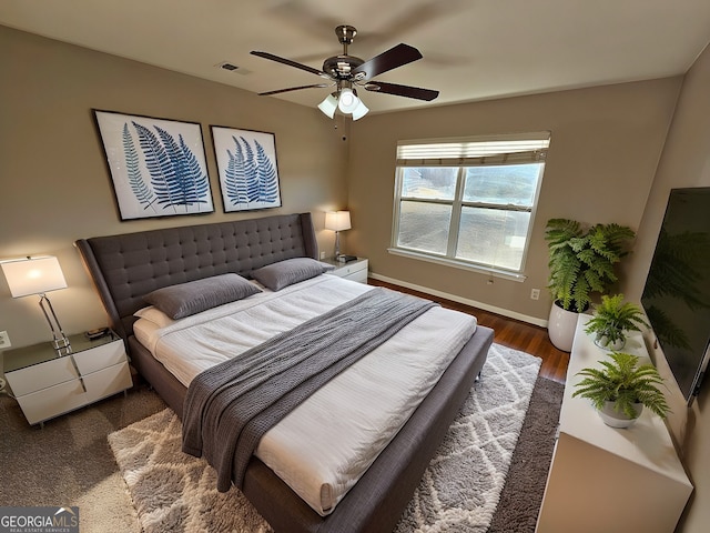 bedroom with ceiling fan and dark hardwood / wood-style floors