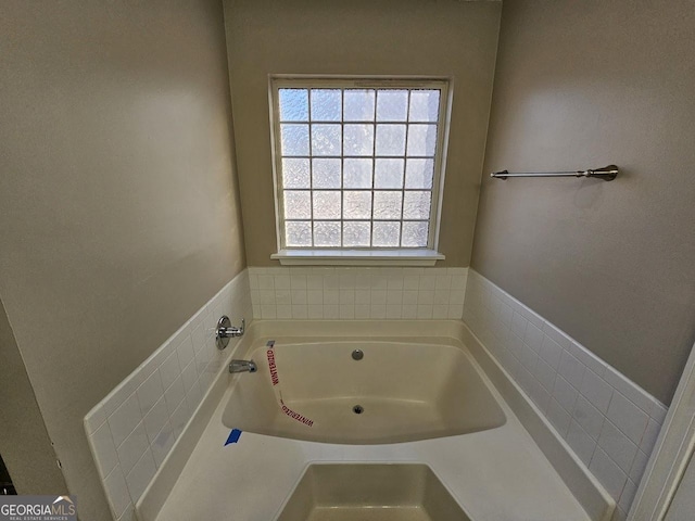 bathroom with a tub to relax in