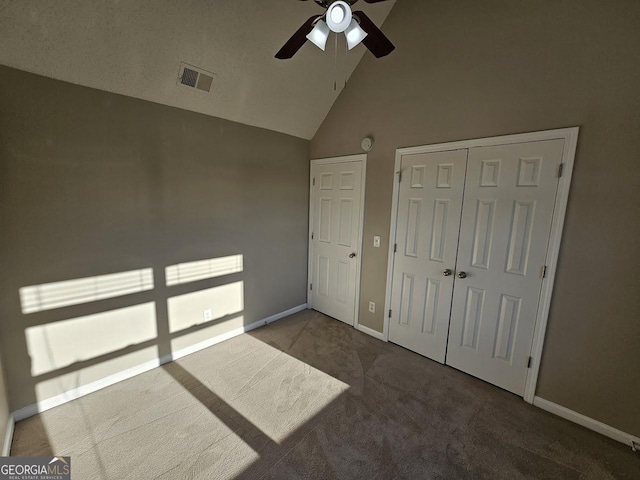 carpeted bedroom with high vaulted ceiling, a closet, and ceiling fan