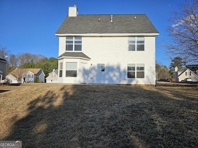 back of house featuring a yard