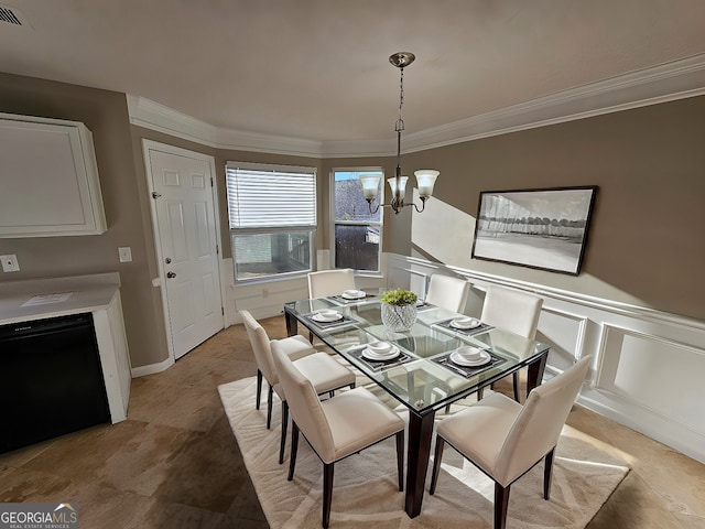 dining area featuring an inviting chandelier and crown molding