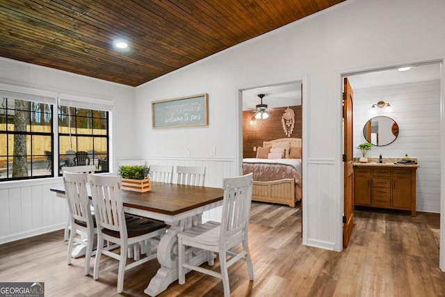 dining area with ceiling fan, wooden ceiling, and light hardwood / wood-style flooring