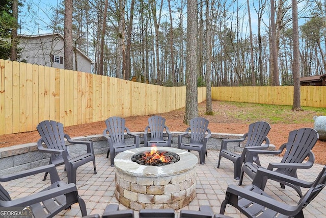 view of patio / terrace featuring an outdoor fire pit