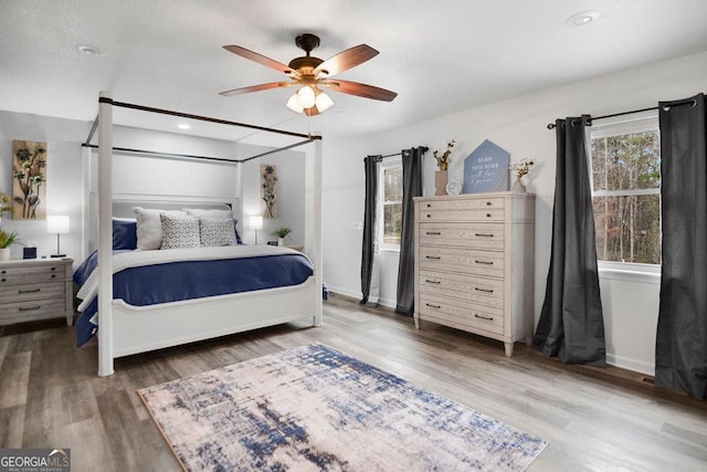 bedroom with ceiling fan and dark hardwood / wood-style flooring