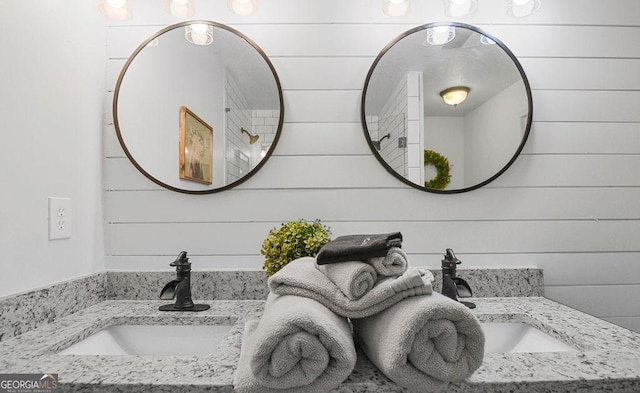 bathroom featuring vanity and wooden walls