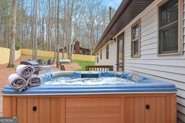 wooden terrace featuring a hot tub