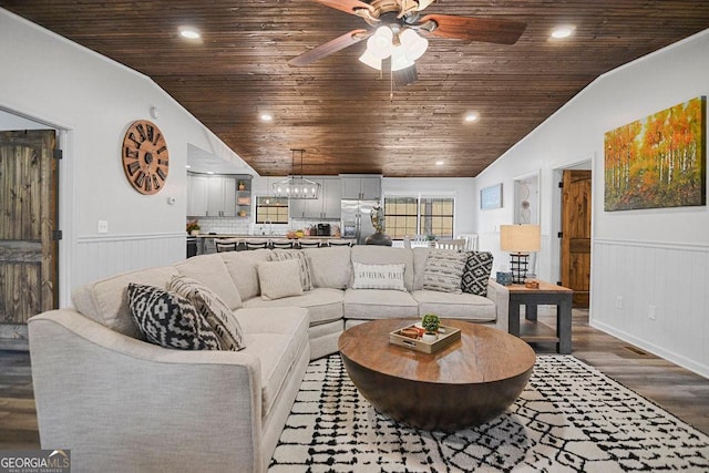 living room with hardwood / wood-style floors, wooden ceiling, ceiling fan with notable chandelier, sink, and vaulted ceiling