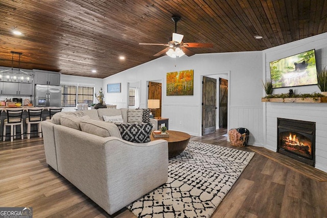 living room with wood-type flooring, ceiling fan, lofted ceiling, and wood ceiling