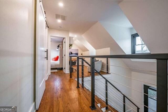 hall featuring wood-type flooring and lofted ceiling