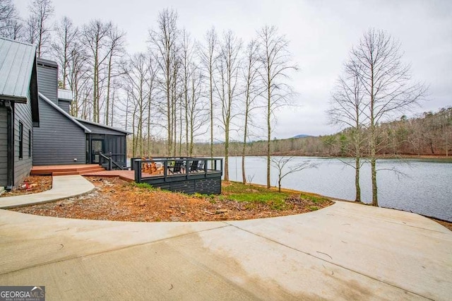 exterior space with a deck with water view