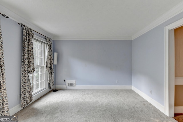 empty room featuring carpet flooring and ornamental molding