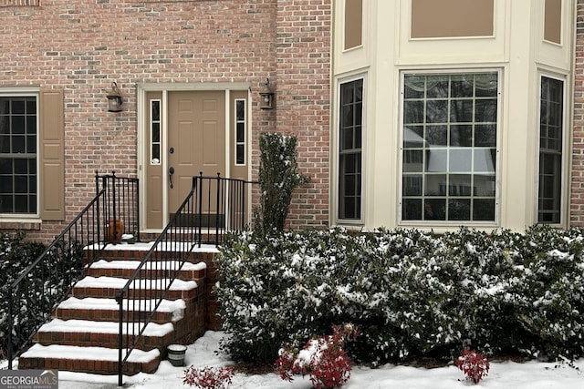 view of snow covered property entrance