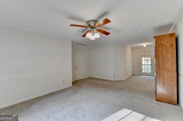 carpeted spare room with a textured ceiling and ceiling fan