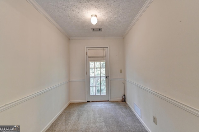 entryway featuring a textured ceiling, crown molding, and light carpet