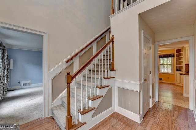 staircase with wood-type flooring