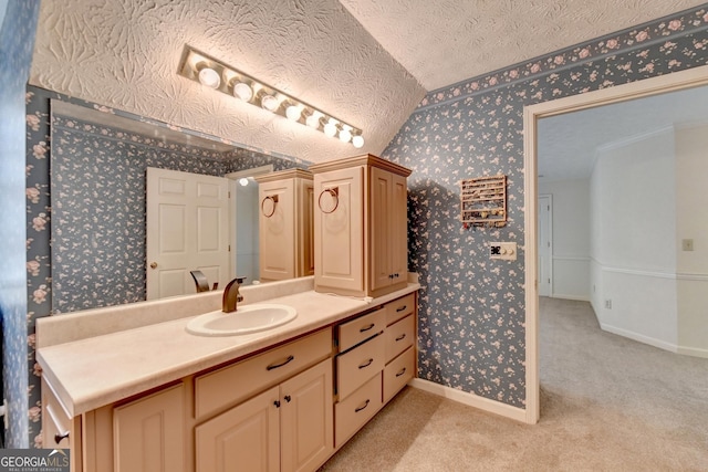 bathroom featuring vanity, a textured ceiling, and vaulted ceiling