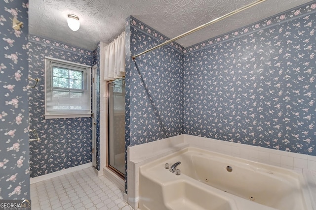 bathroom with plus walk in shower and a textured ceiling