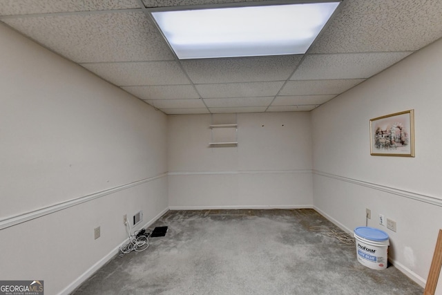 interior space with carpet and a drop ceiling