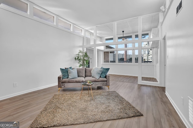 living room featuring hardwood / wood-style floors and ceiling fan