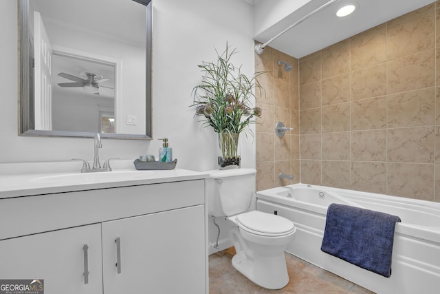 full bathroom with tile patterned floors, vanity, tiled shower / bath combo, ceiling fan, and toilet