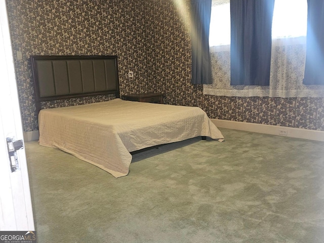 carpeted bedroom featuring baseboards and wallpapered walls