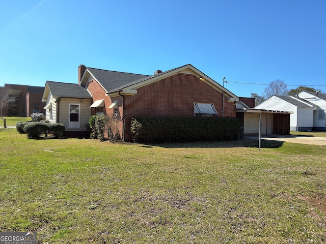 view of property exterior with a lawn and brick siding