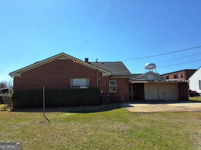 back of property featuring a patio, brick siding, and a lawn