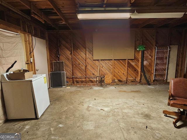 miscellaneous room with washer / dryer and wooden walls