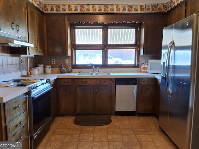 kitchen featuring stainless steel appliances, tasteful backsplash, light countertops, dark brown cabinets, and under cabinet range hood