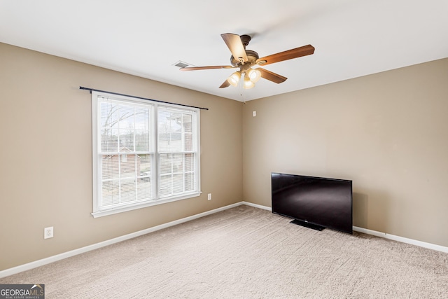 spare room with ceiling fan and light colored carpet