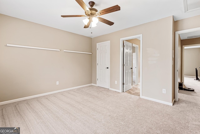 unfurnished bedroom featuring light colored carpet and ceiling fan