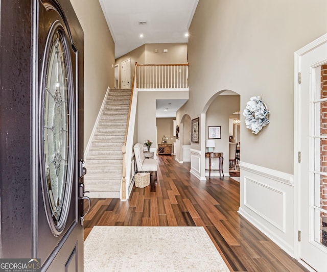 entrance foyer featuring dark hardwood / wood-style flooring and ornamental molding