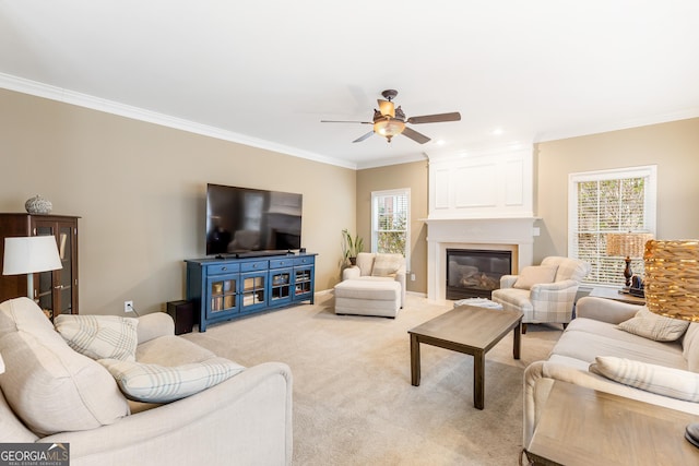 living room featuring ceiling fan, a fireplace, light colored carpet, and plenty of natural light