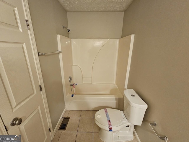 bathroom featuring toilet, tile patterned flooring, a textured ceiling, and  shower combination