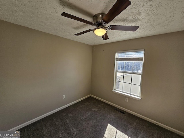 carpeted empty room with a textured ceiling and ceiling fan