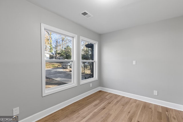 spare room featuring light hardwood / wood-style flooring