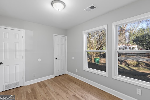 spare room with light hardwood / wood-style floors