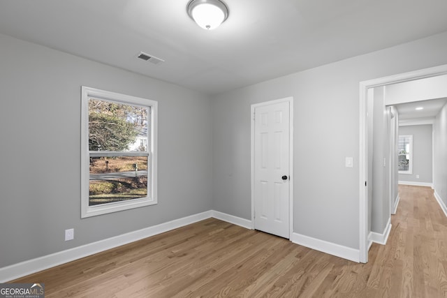 unfurnished bedroom featuring a closet and light hardwood / wood-style flooring