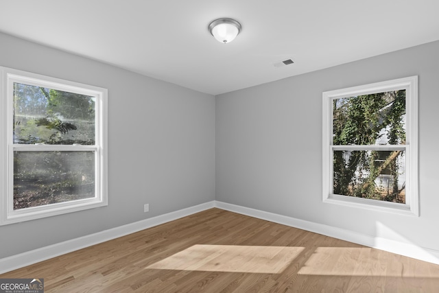 spare room featuring light hardwood / wood-style flooring