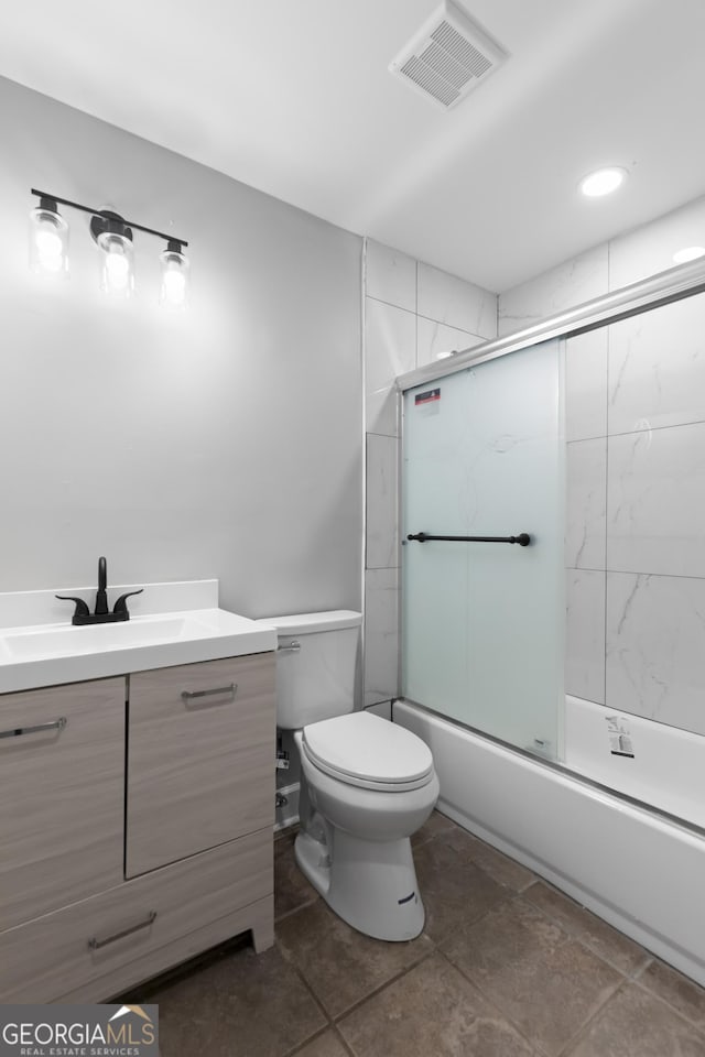 full bathroom with vanity, enclosed tub / shower combo, and toilet