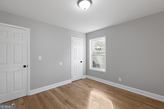 empty room with light hardwood / wood-style flooring