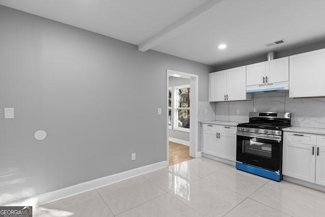 kitchen featuring white cabinets, tasteful backsplash, stainless steel range with gas cooktop, and beamed ceiling