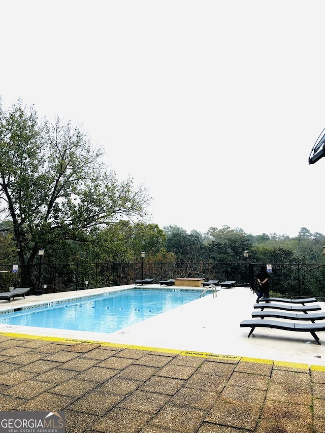 view of swimming pool with a patio