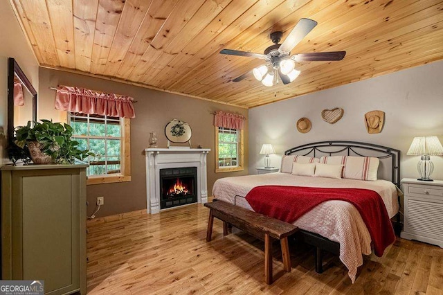 bedroom with ceiling fan, hardwood / wood-style floors, and wooden ceiling