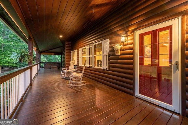 wooden terrace featuring covered porch